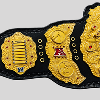 Custom gold fantasy football championship belt left side plates with team logos, engraved details, and red gemstones.