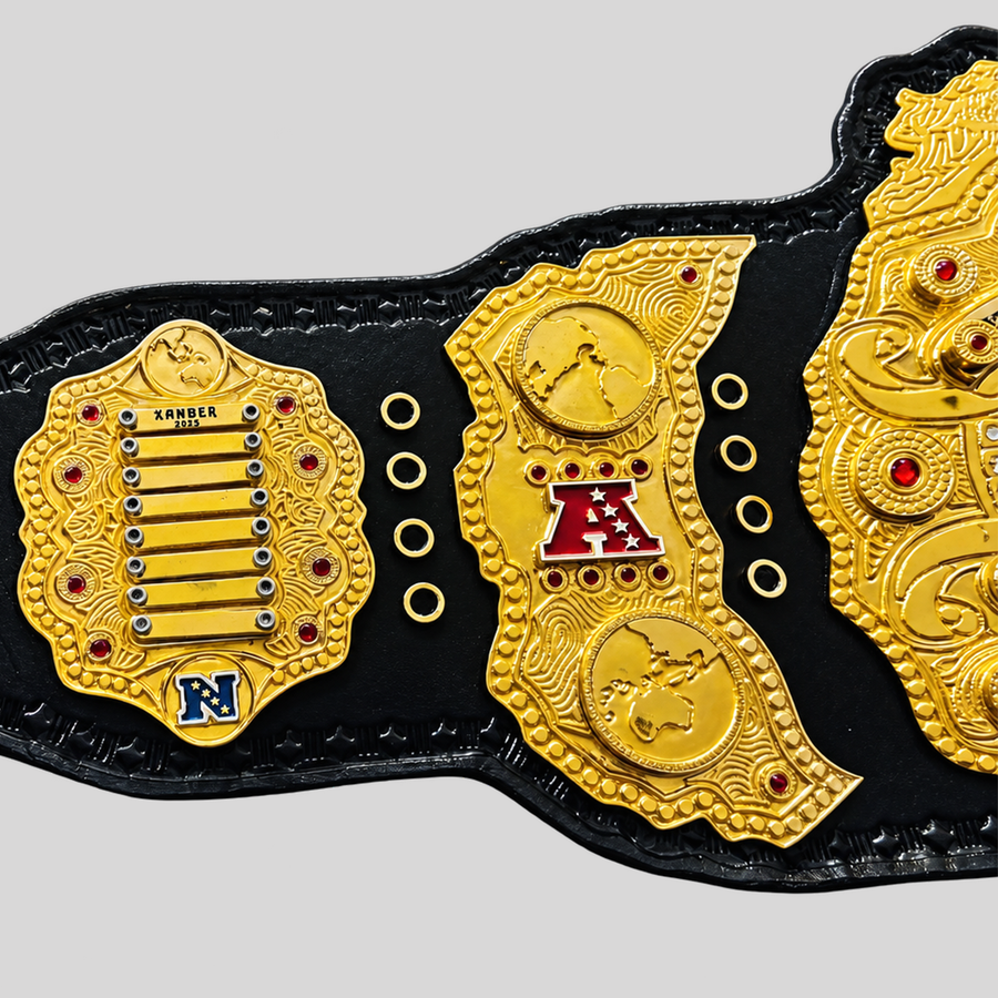 Custom gold fantasy football championship belt left side plates with team logos, engraved details, and red gemstones.