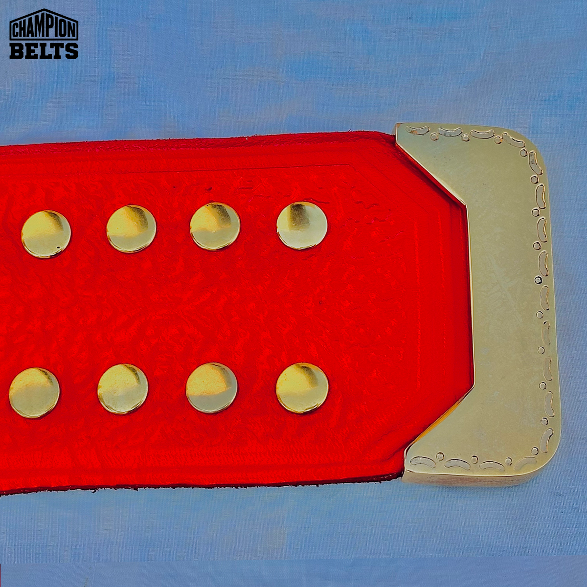 Custom Moon League championship belt with red strap, gold fastening hardware, and adjustable snap closure